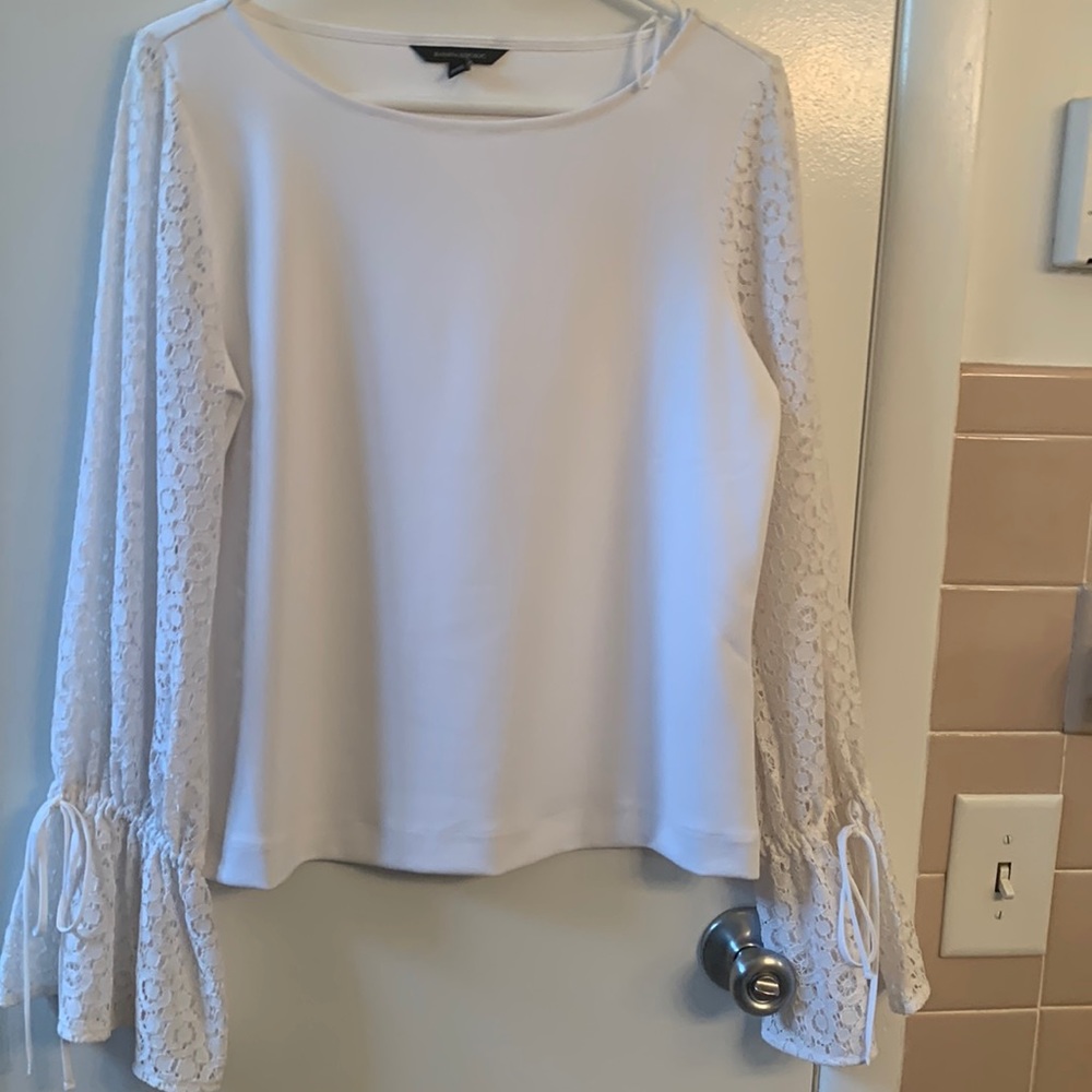 Beautiful white blouse with lacy sleeves with ties